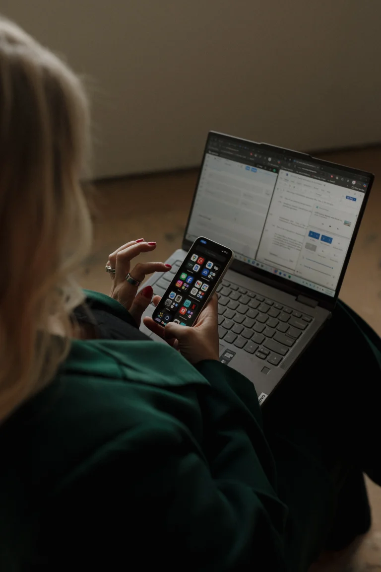Business Advisor scrolling through her messages while working on the laptop for emro law 